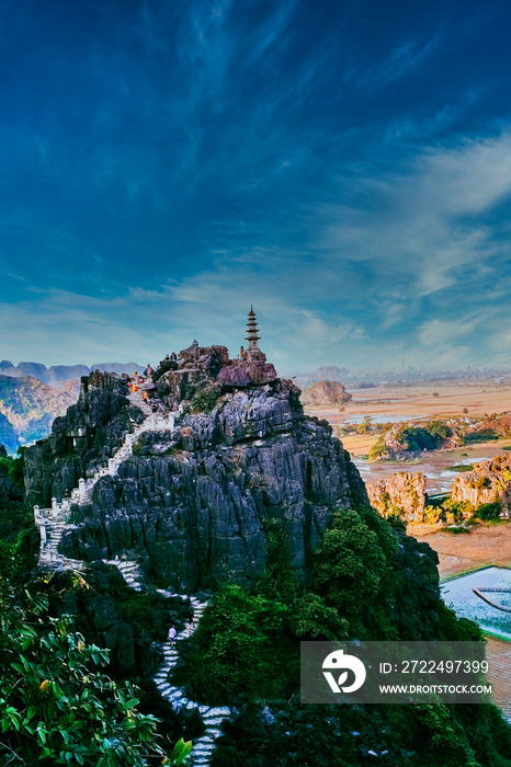 Beautiful sunset landscape of buddhist temple of Hang Mua : 486 stone step up to the top of Ngoa Long mountain, at Ninh Binh Province, Vietnam