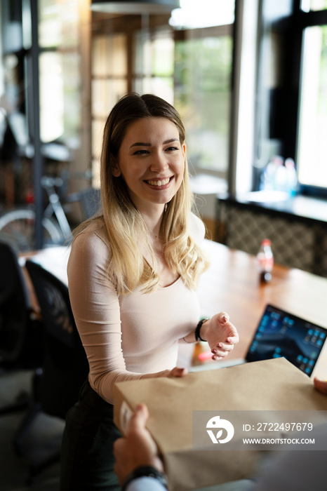 Beautiful businesswoman receiving a package. Young woman in the office