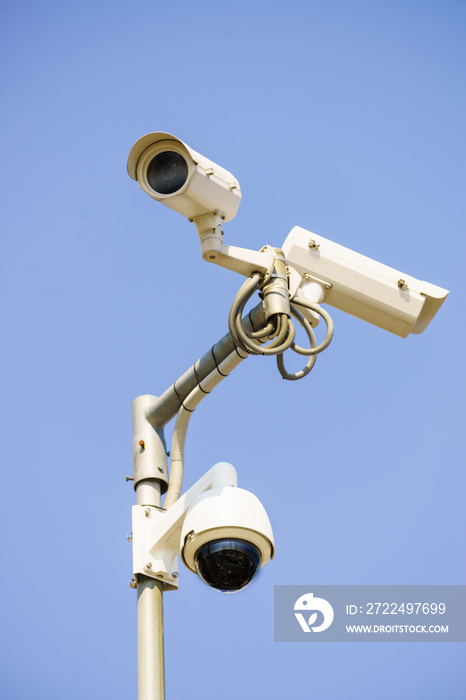 Three white urban CCTV security cameras
