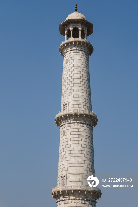 The  ivory -white marble minaret  the  Taj Mahal, the famous mausoleum in Agra, India.