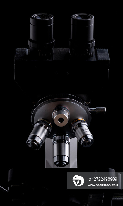 Closeup of Scientific microscope isolated on black, data analysis in the laboratory