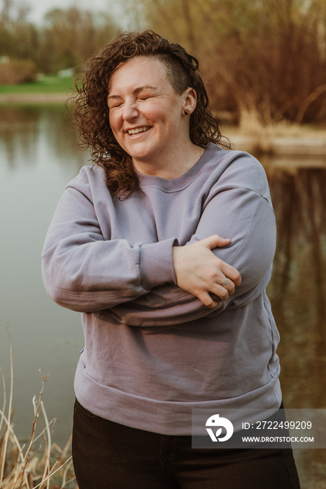 portrait of a plus size woman hugging self