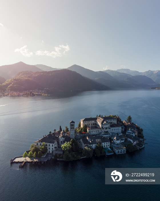 Vertical aerial shot of San Giulio island on lake Orta at sunset.