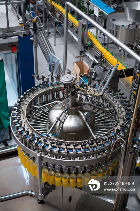 Bottles being filled with juice on production line