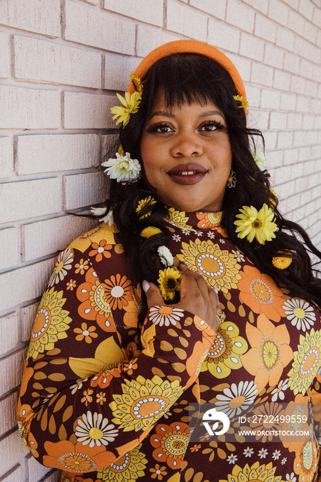 closeup of plus size Black woman with flowers in her hair