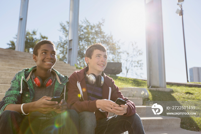 Teenage boys sitting on steps at skate park