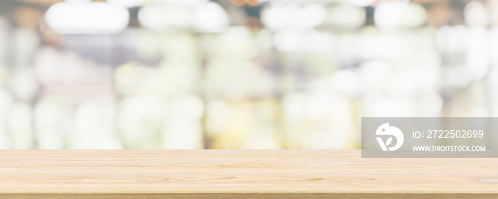 Empty wooden table top with cafe restaurant or coffee shop window interior abstract blur defocused w