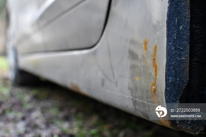 Signs of car corrosion or rust appearing on the bottom of the car.