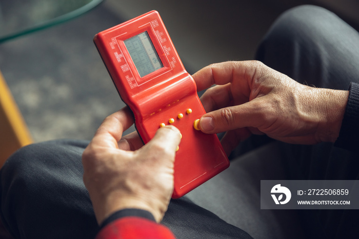 Portrait of senior man with retro toys, meeting things from the past and having fun, exploring the l