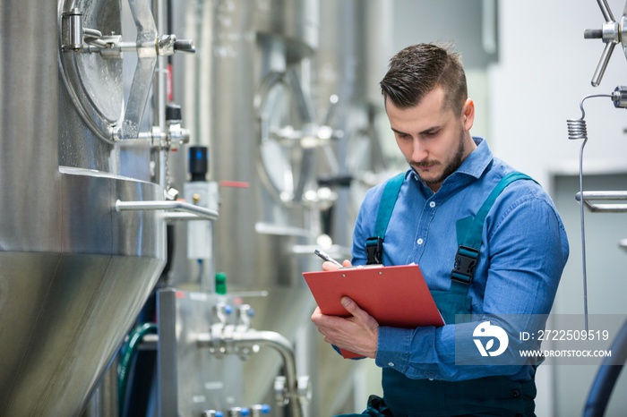 Maintaince worker wrting on clipboard