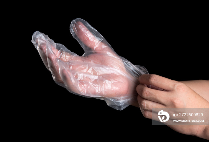 Man hand wearing disposable plastic glove on black background