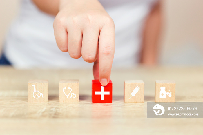 Health Insurance Concept,hand arranging wood block stacking with icon healthcare medical.