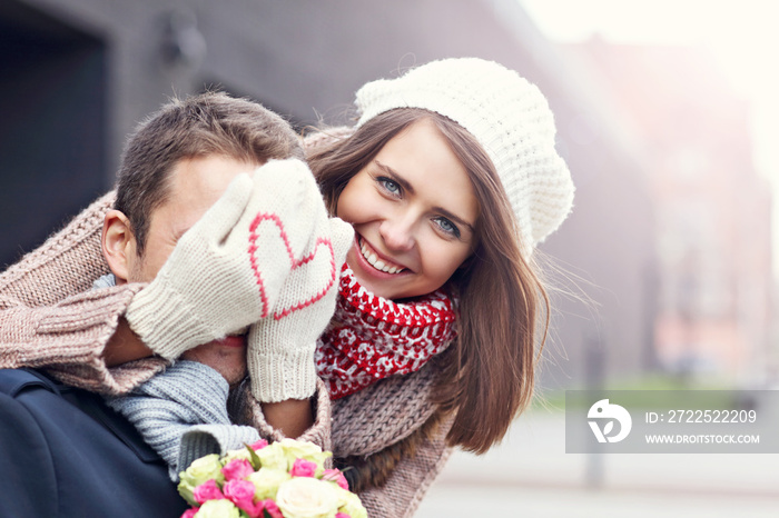 Young couple with flowers dating in the city