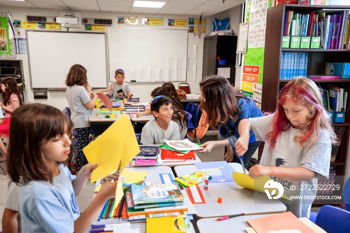 Teacher helping children in a classroom