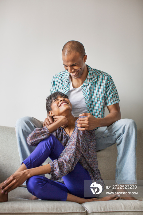 Smiling couple sitting on sofa