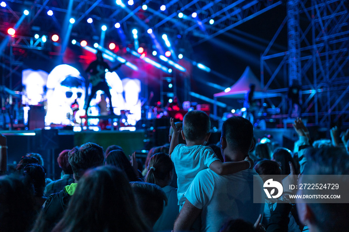 Boy and dad in the crowd at a concert