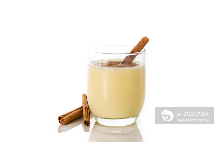 Homemade eggnog with cinnamon in glass isolated on white background. Typical Christmas dessert.