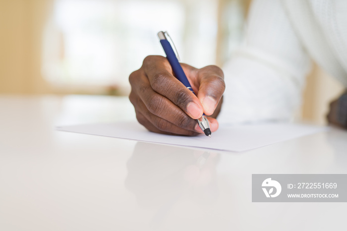 Close up of african man writing a note on a paper