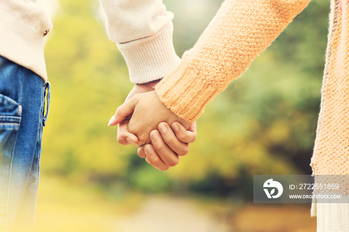 Couple holding hands in the park