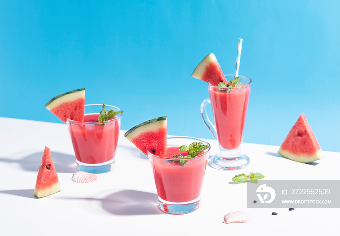 Fresh water melon juice and watermelon slice on color background. summer drink.