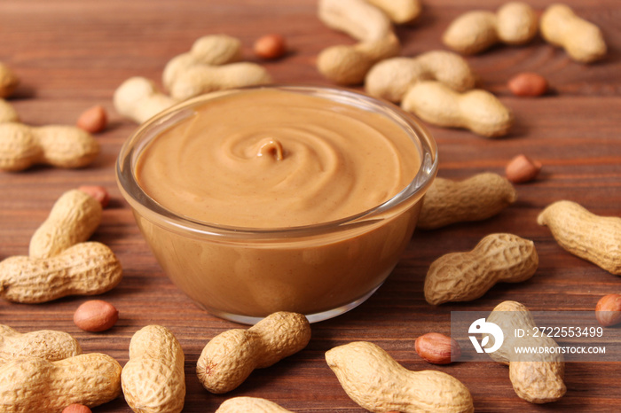 peanut butter and peanut beans on wooden background