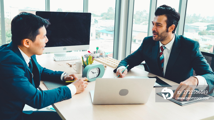 Two business people talk project strategy at office meeting room. Businessman discuss project planni