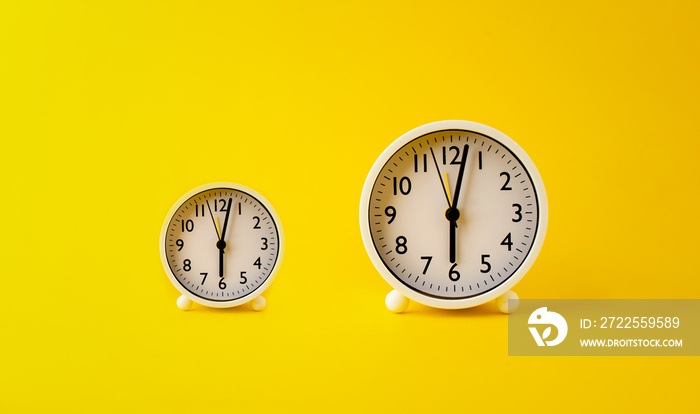 concept of time two white watches placed on a yellow background rotation of time