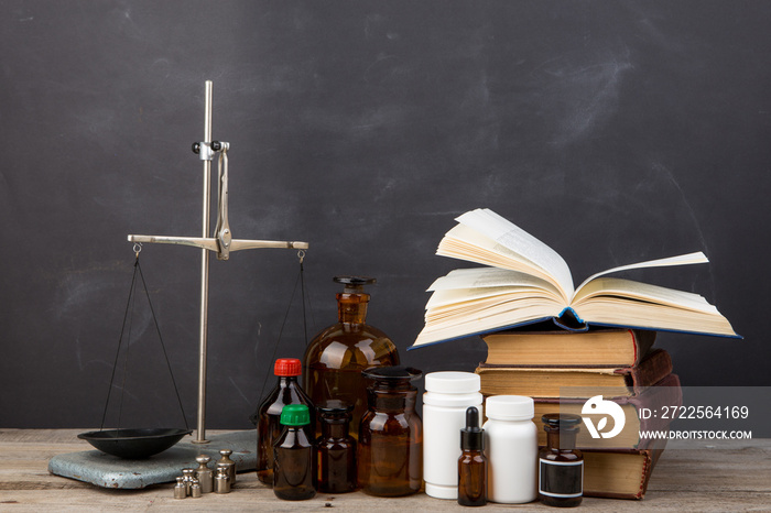 Medical education concept - books, pharmacy bottles, stethoscope in the auditorium with blackboard