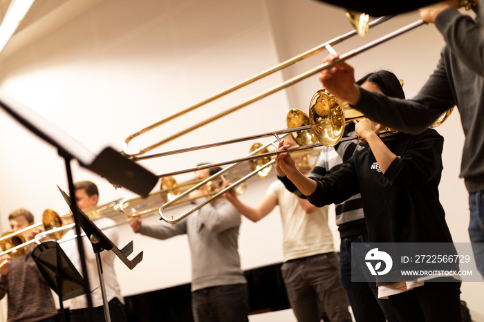 Many people playing the trombone