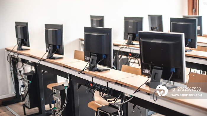 Photo of row computers in classroom or other educational institution