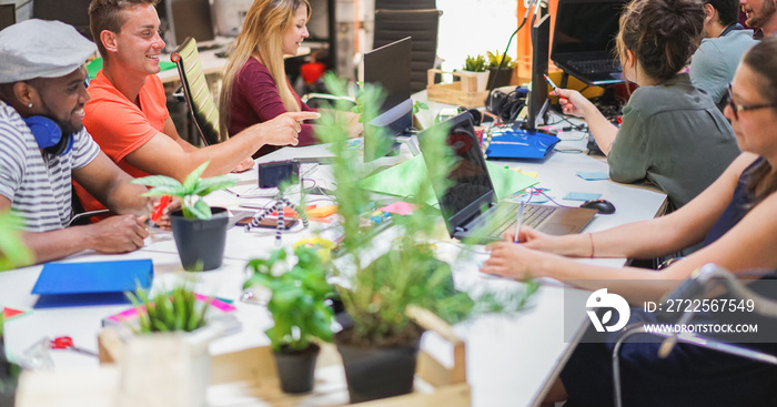 Young co-workers team talking during startup - Happy people planning a new project in creative cowor