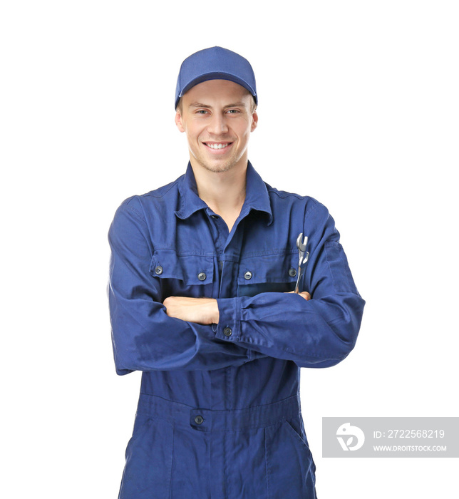 Young mechanic in uniform with wrenches on white background