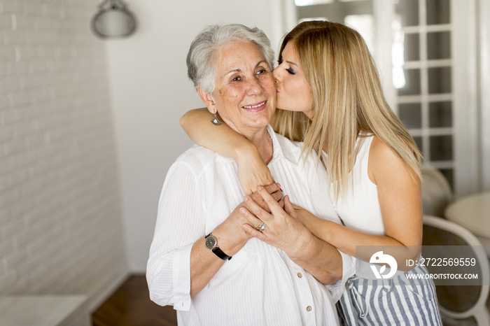 Grandmother kissing granddaughter