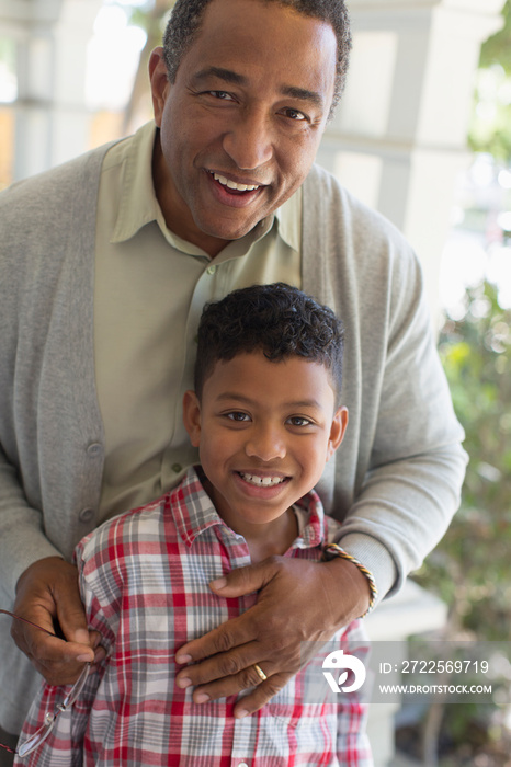 Portrait happy grandfather and grandson hugging