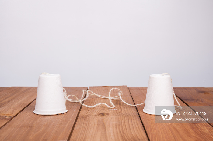 classic paper cup phone on wood background