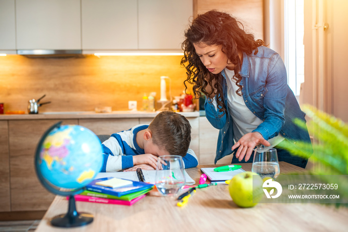 Child having problem with concentration while doing homework. Stressed Mother and Son Frustrated Ove