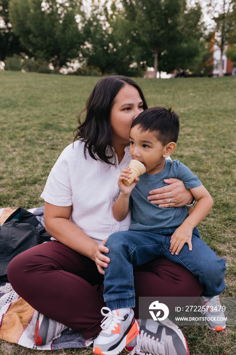 Mother and child eating ice cream in park