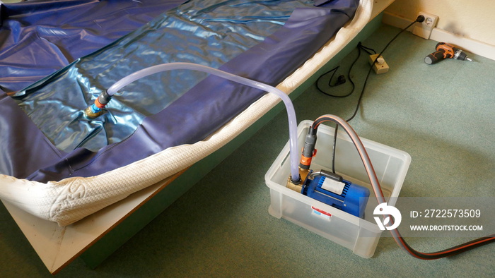 Emptying a PVC waterbed mattress with an electric pump