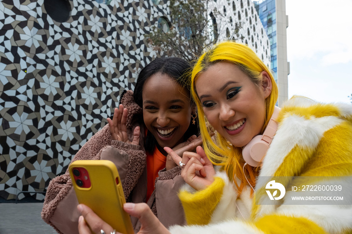 Smiling young friends having video call