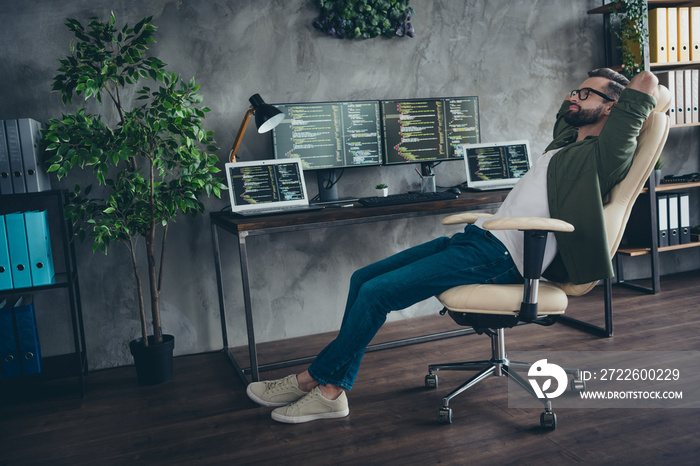 Profile side view portrait of attractive dreamy guy student developing web project start-up relax in armchair at workplace station indoors