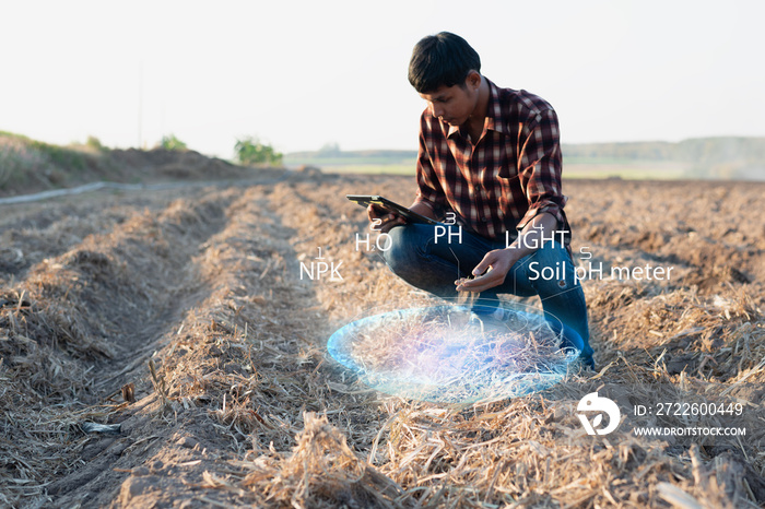 IoT(Internet of Things)smart agriculture industry 4.0,5.0 concept.farmer working in farm To collect data to study and develop his farm to improved productivity in the future.