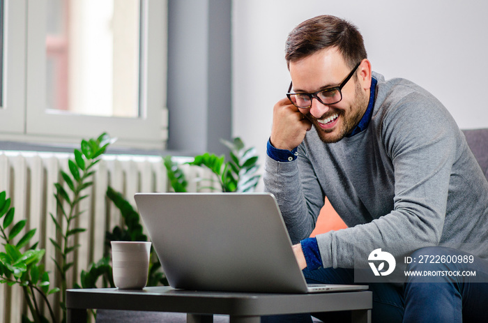 Handsome positive and cheerful man with glasses smiling at his online date