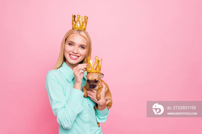 Portrait of cute lady having diadem smiling wearing mint-colored shirt isolated over pink background