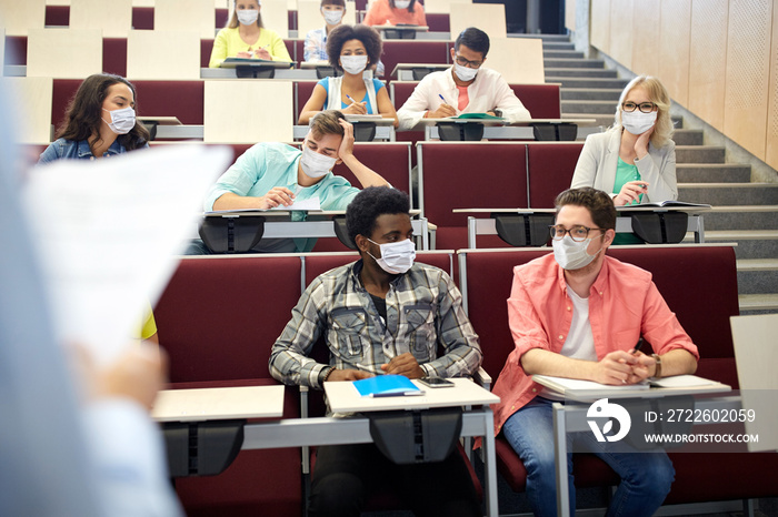 education, pandemic and health concept - group of international students wearing face protective medical mask for protection from virus disease at lecture hall