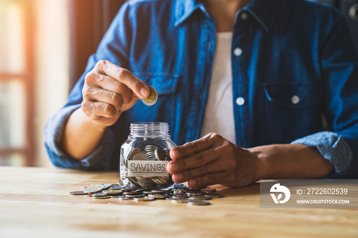 Woman puts a coin in a jar to save money for the future. after retirement and income, expenditure, savings and financial concepts