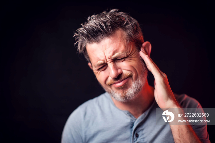 Man feels strong ear pain. People, healthcare and medicine concept