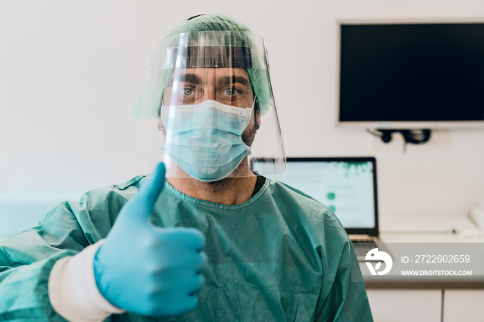 Doctor wearing ppe face surgical mask and visor fighting against corona virus outbreak - Health care and medical workers concept