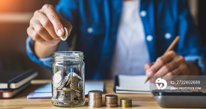 housewife puts a coin in a jar to save money for the future. after retirement and record keeping of income, expenditure, savings and financial concepts.