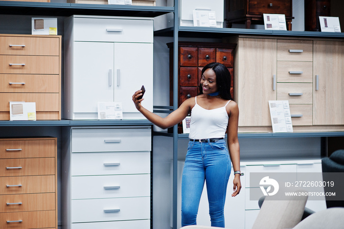 Portrait of a beautiful african american woman taking a selfie in the shop.