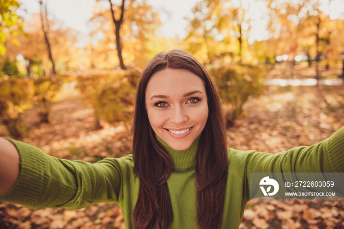 Closeup portrait selfie photo of pretty lovely cheerful lady autumn park leaves cover ground shiny smiling stay among trees beautiful sunny warm weather wear green turtleneck outdoors